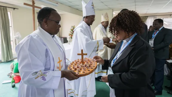Rev. Catherine Ngina Musa of the Kenya Evangelical Lutheran Church – one of the hosting churches – distributes wine during Holy Communion, at the opening worship. Rev. Catherine Ngina Musa of the Kenya Evangelical Lutheran Church – one of the hosting churches – distributes wine during Holy Communion, at the opening worship.