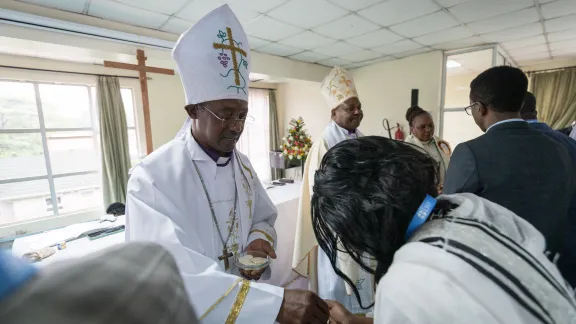 Bishop Johnes Meliyio of the Kenya Evangelical Lutheran Church distributes bread for holy communion. Bishop Johnes Meliyio of the Kenya Evangelical Lutheran Church distributes bread for holy communion.