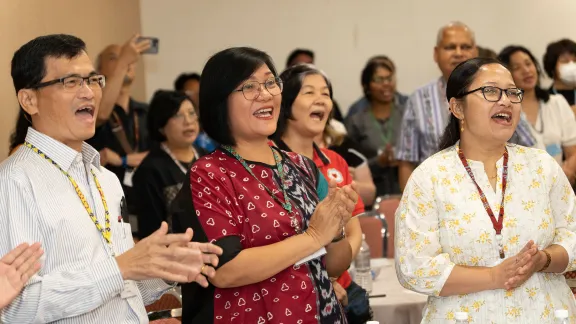 LWF Council members from the Asia region rejoicing and singing during the morning devotion. From left: Rev. Aaron Yap, Desri Sumbayak and Ranjita Borgoary. Photo: LWF/Jotham Lee
