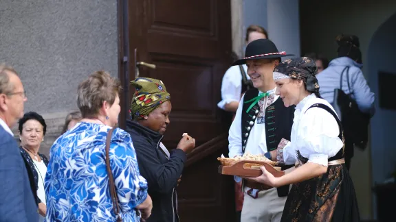 Local congregants welcoming Lutherans from around the globe joining Sunday worship at the Lutheran church in Bystřice, Czech Republic, with bread and salt. Photo: LWF/Marie Renaux